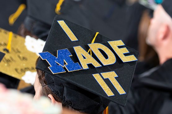 Top of a graduation cap reading "I Made It" with a Block M as the "M" in "Made"