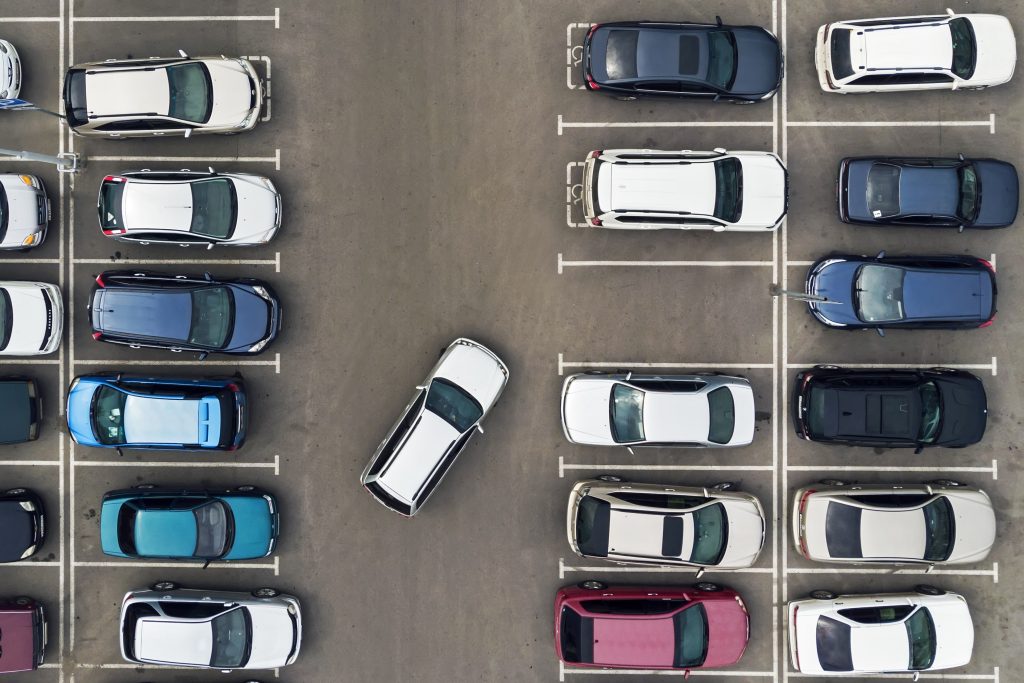 Aerial view of vehicles parking in a parking lot.
